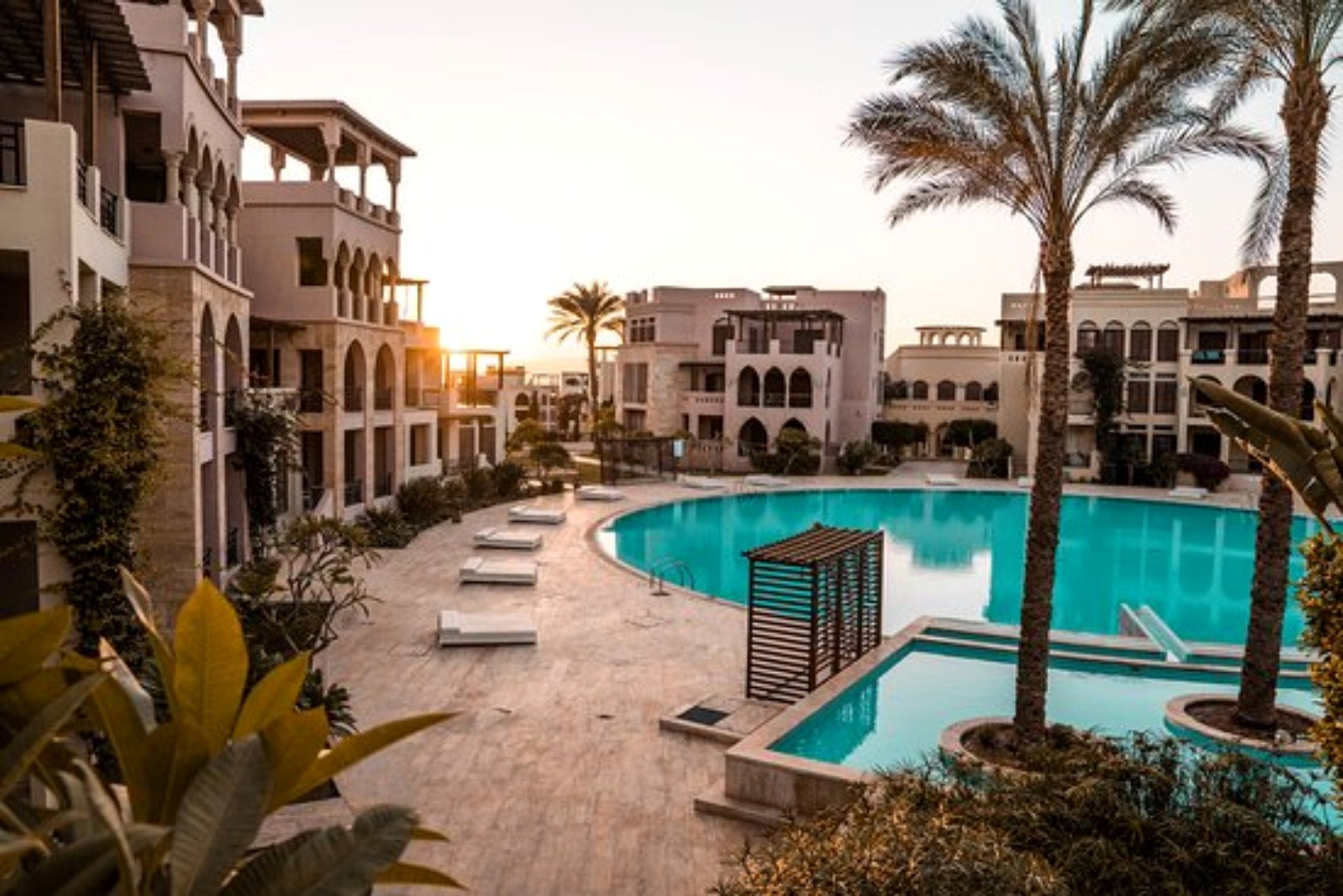 Tala Bay residences and pool at sunset